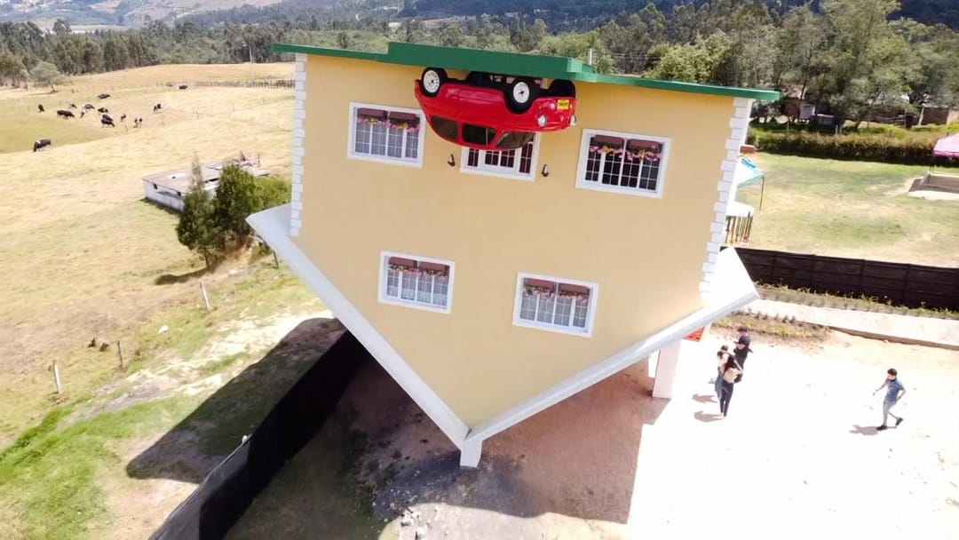 Colombian tourists are invited to walk around an unusual upside down house